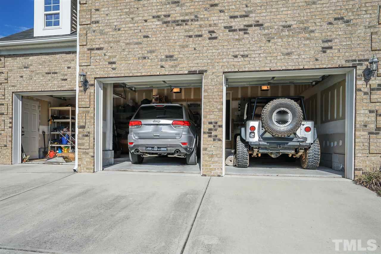 1604 Pattersons Mill Road Durham, NC 27703 - Photo 24 of 30 3 car garage with separate doors are generous enough for off road vehicles plus storage. Built in shelves remain. Convenient utility sink and exterior side door to yard.