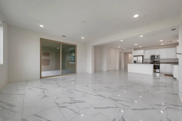 a view of a hallway with cabinets