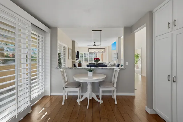 a view of a dining room with furniture and wooden floor