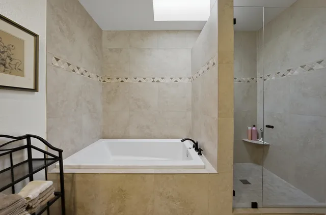 a bathroom with a bathtub and shower