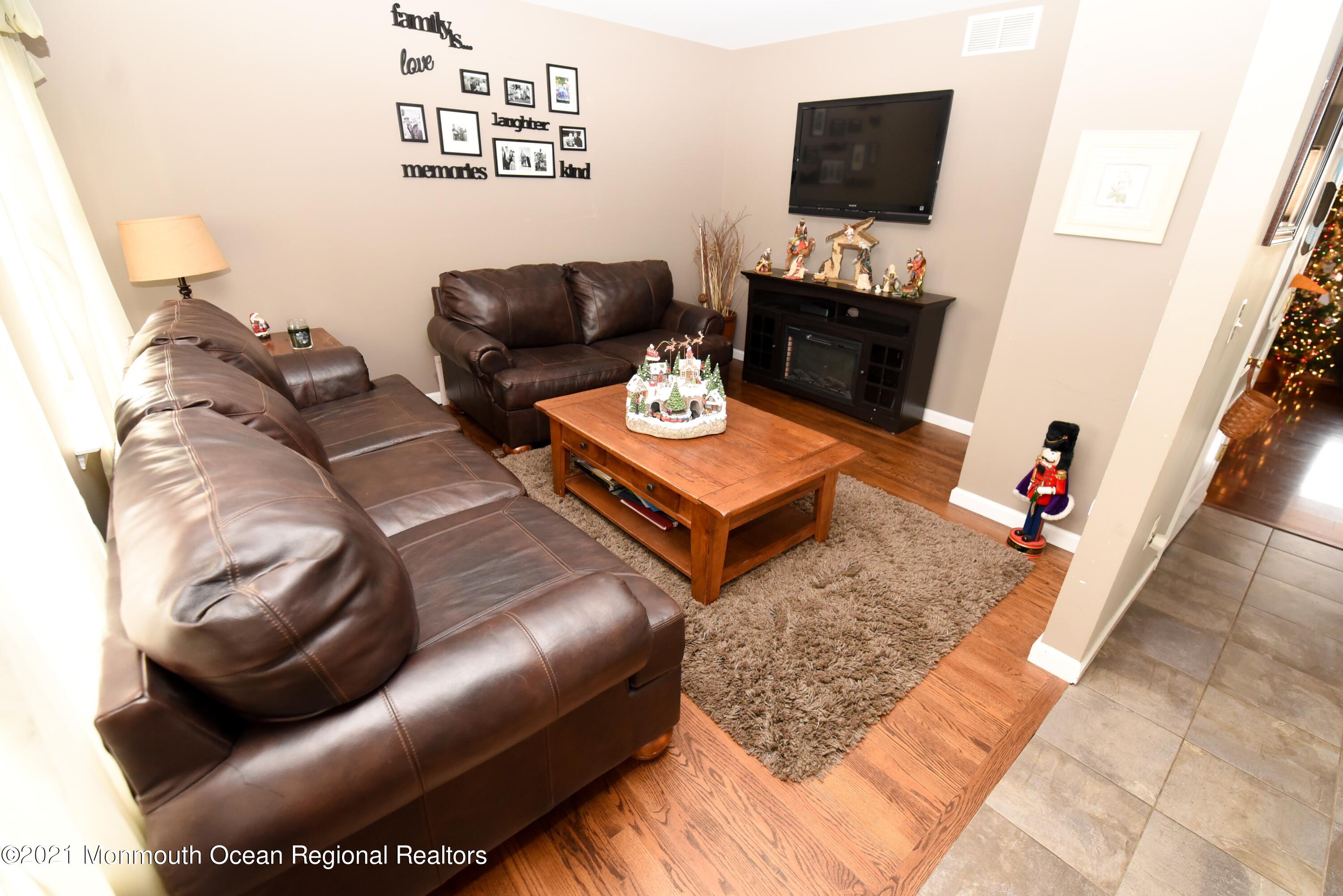 57 Mutineer Avenue Barnegat, NJ 08005 - Photo 16 of 89 a living room with furniture and a flat screen tv