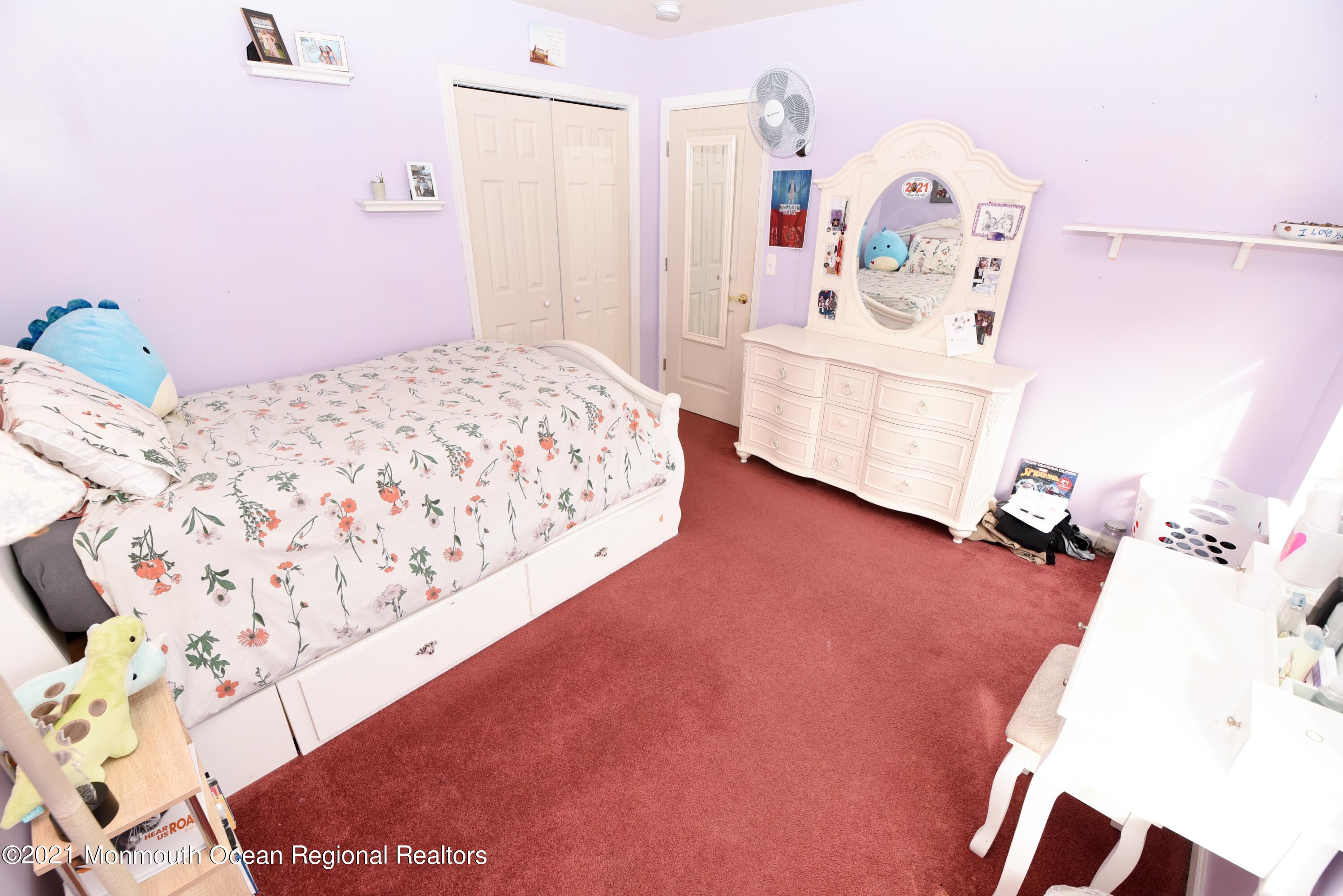 57 Mutineer Avenue Barnegat, NJ 08005 - Photo 48 of 89 a bedroom with a bed and a chandelier