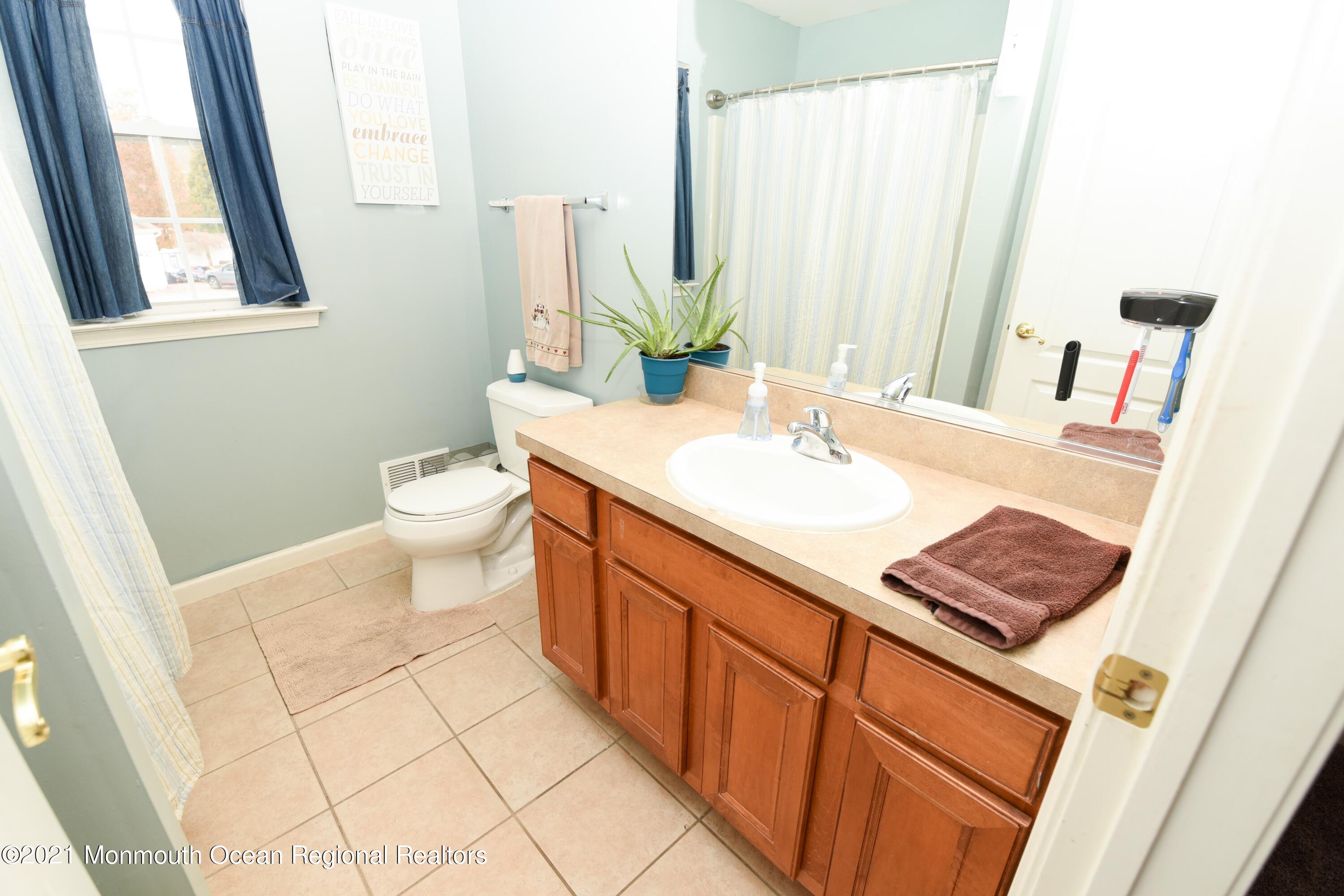 57 Mutineer Avenue Barnegat, NJ 08005 - Photo 54 of 89 a bathroom with a sink a toilet and a mirror