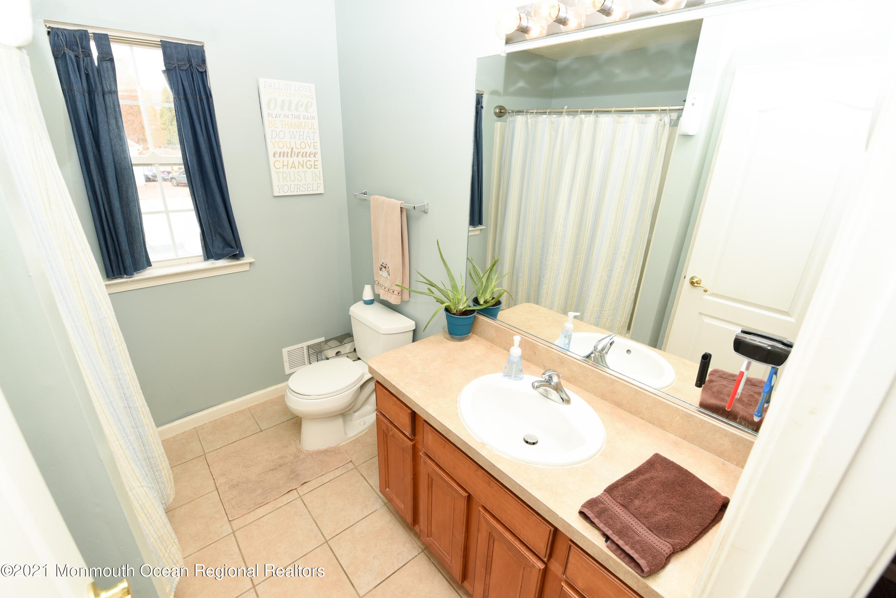 57 Mutineer Avenue Barnegat, NJ 08005 - Photo 55 of 89 a bathroom with a sink toilet and mirror