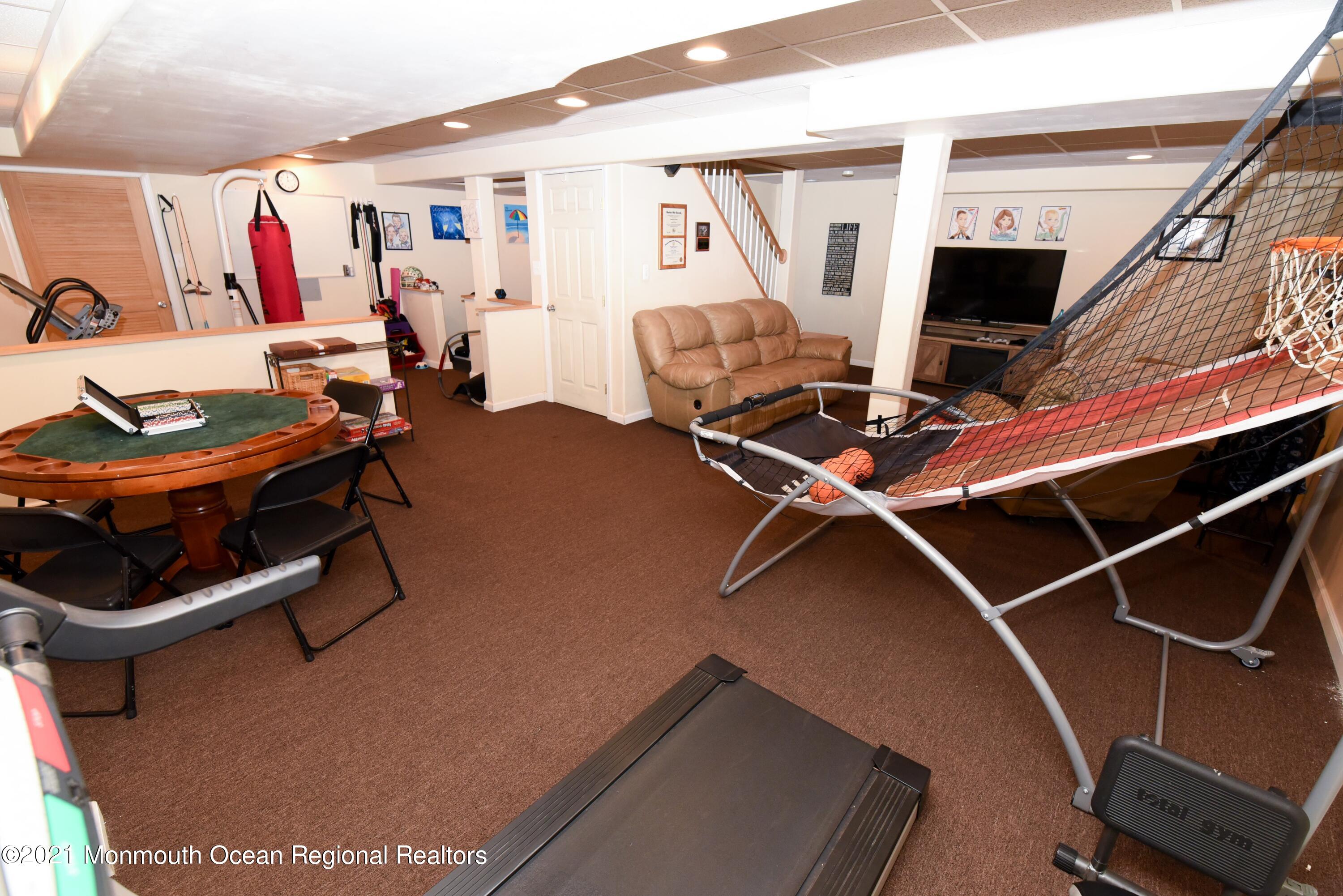 57 Mutineer Avenue Barnegat, NJ 08005 - Photo 63 of 89 a room with gym equipment and a flat screen tv