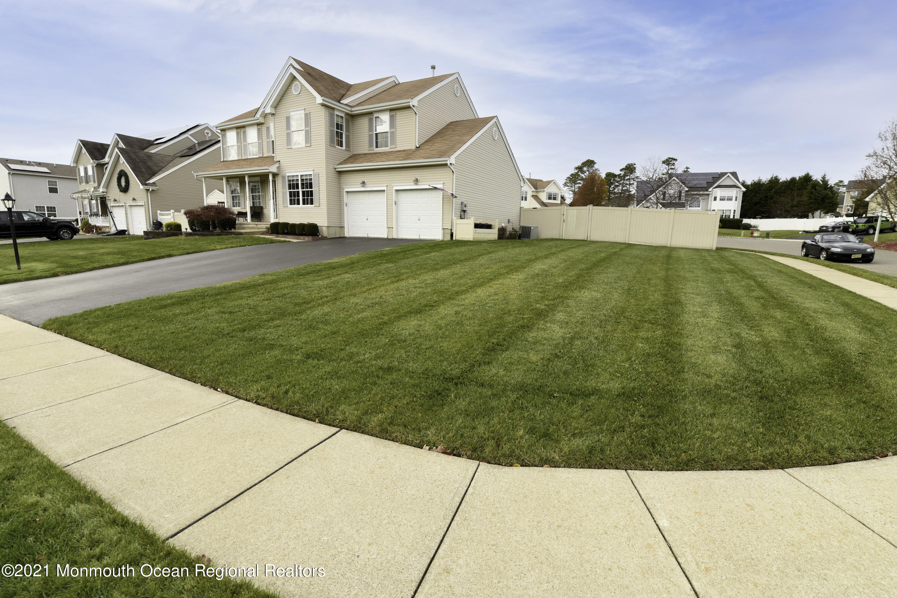 57 Mutineer Avenue Barnegat, NJ 08005 - Photo 84 of 89 a view of a white house next to a yard with big trees
