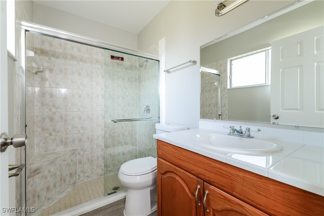 2809 Greendale Road North Port, FL 34287 - Photo 11 of 16 a bathroom with a sink a toilet and shower