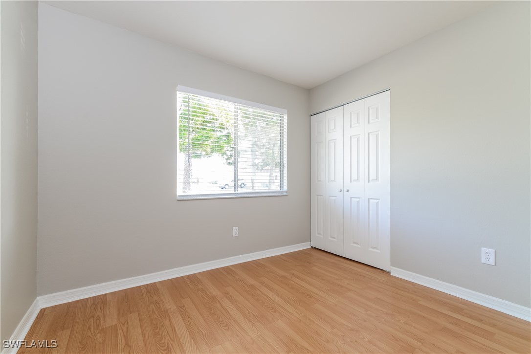 2809 Greendale Road North Port, FL 34287 - Photo 12 of 16 an empty room with wooden floor and windows