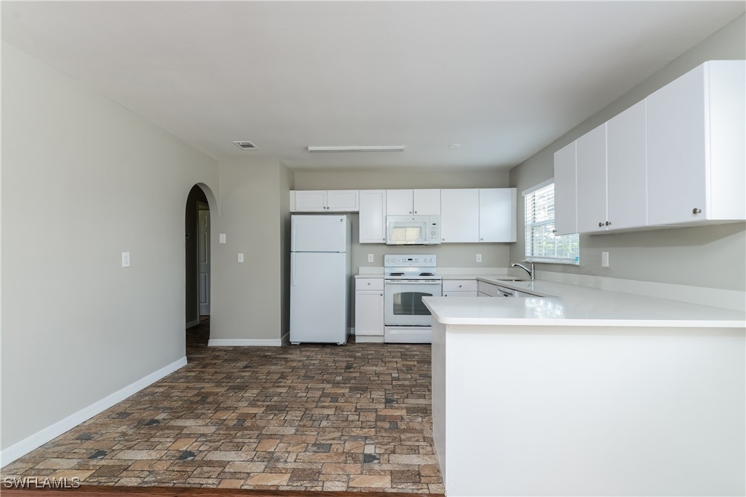 2809 Greendale Road North Port, FL 34287 - Photo 5 of 16 a kitchen with a sink stove and refrigerator