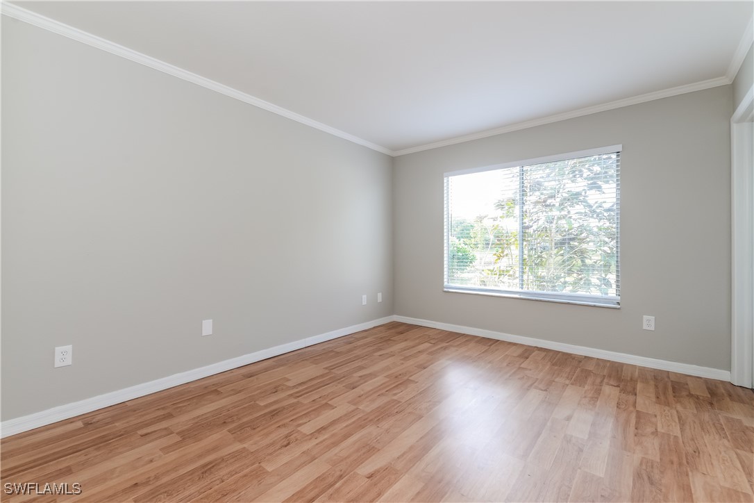 2809 Greendale Road North Port, FL 34287 - Photo 9 of 16 an empty room with wooden floor and windows