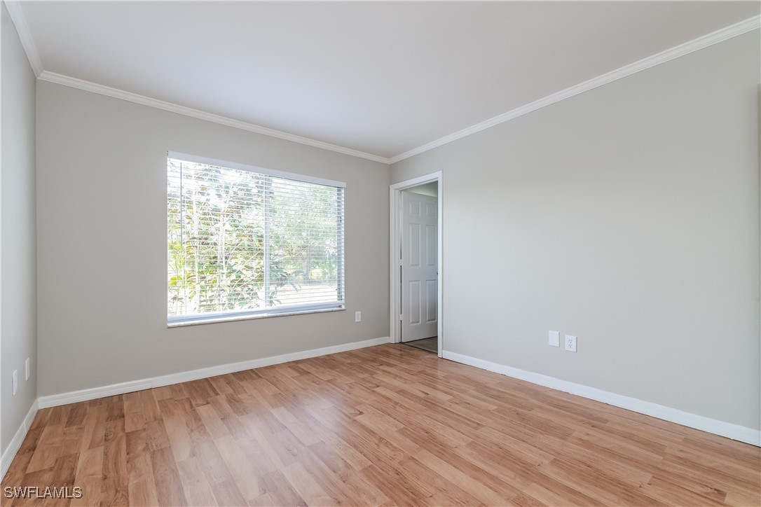 2809 Greendale Road North Port, FL 34287 - Photo 10 of 16 an empty room with wooden floor and windows