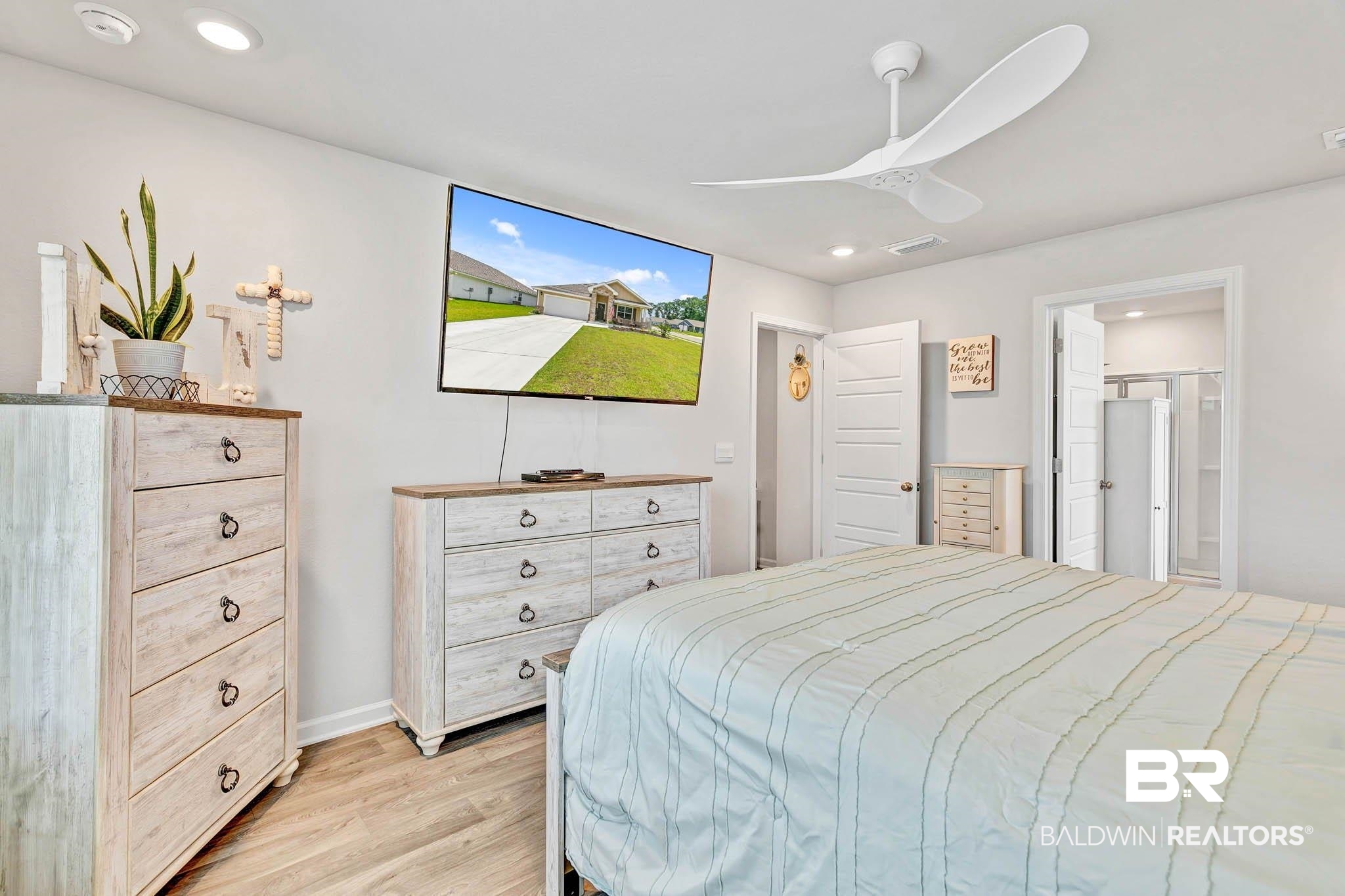 17217 REFLECTION Street Loxley, AL 36551 - Photo 23 of 83 Primary Bedroom off the great room with light wood lvp finished floors, a ceiling fan, and recessed lighting