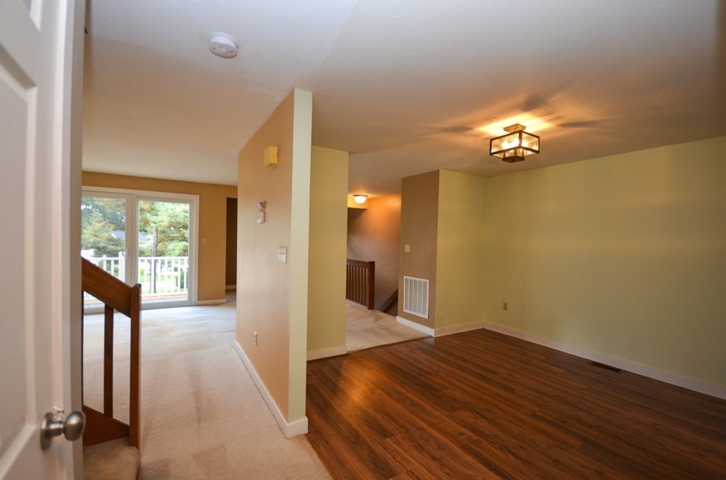 19 Millers Way, Unit C Sutton, MA 01590 - Photo 13 of 37 a view of a room with wooden floor and a ceiling fan