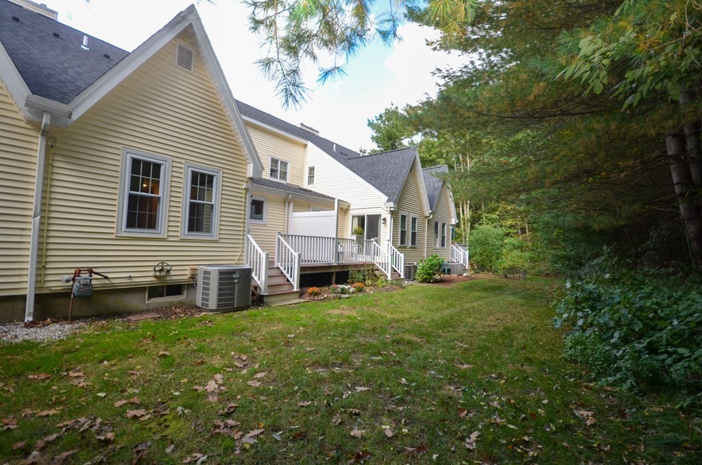 19 Millers Way, Unit C Sutton, MA 01590 - Photo 19 of 37 a front view of a house with a yard