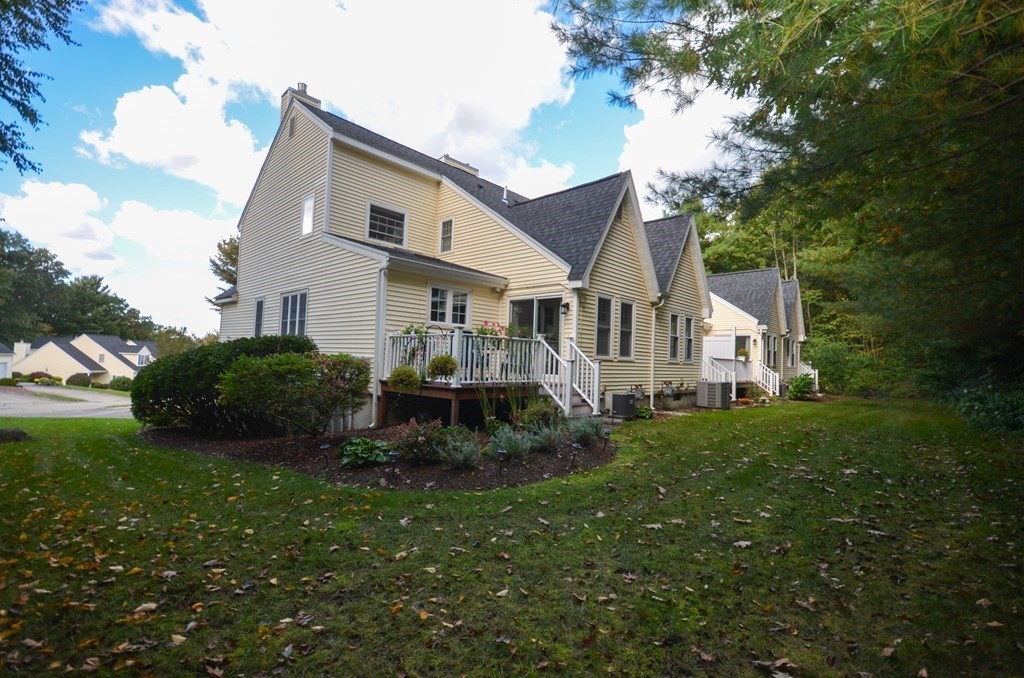 19 Millers Way, Unit C Sutton, MA 01590 - Photo 20 of 37 a view of a house with a big yard and large trees