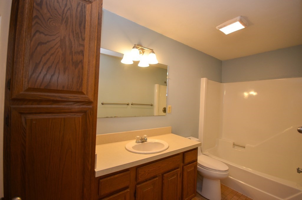 19 Millers Way, Unit C Sutton, MA 01590 - Photo 22 of 37 a bathroom with a sink a toilet and a mirror