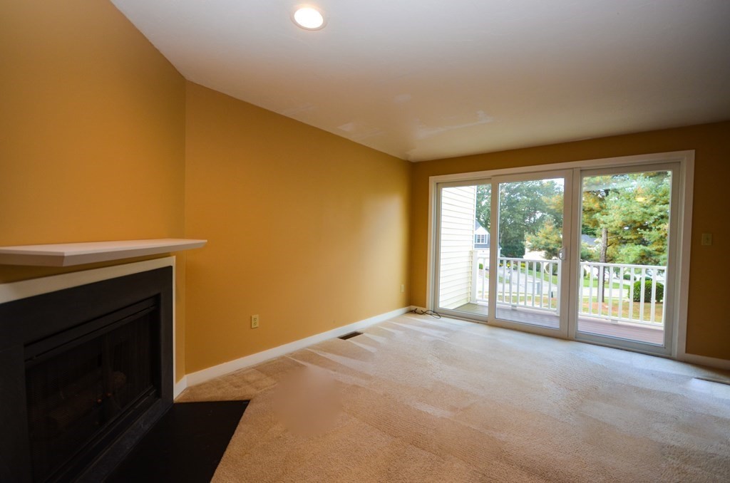 19 Millers Way, Unit C Sutton, MA 01590 - Photo 5 of 37 a view of an empty room with a fireplace