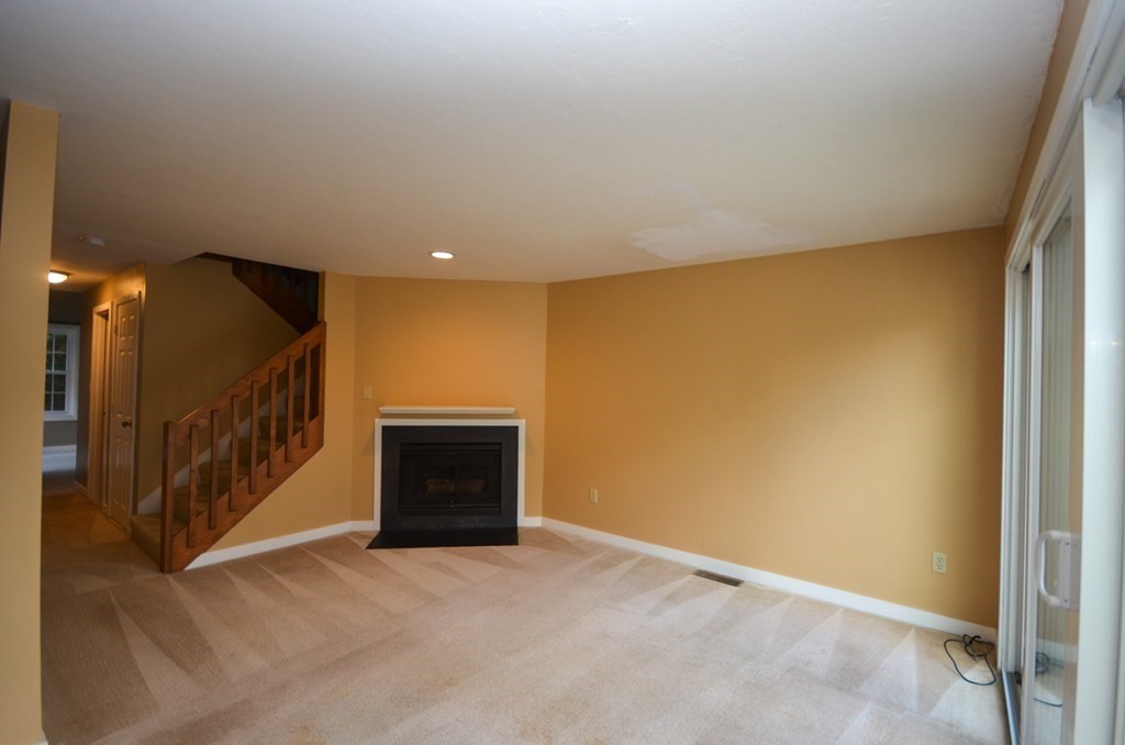 19 Millers Way, Unit C Sutton, MA 01590 - Photo 9 of 37 a view of an empty room with a fireplace