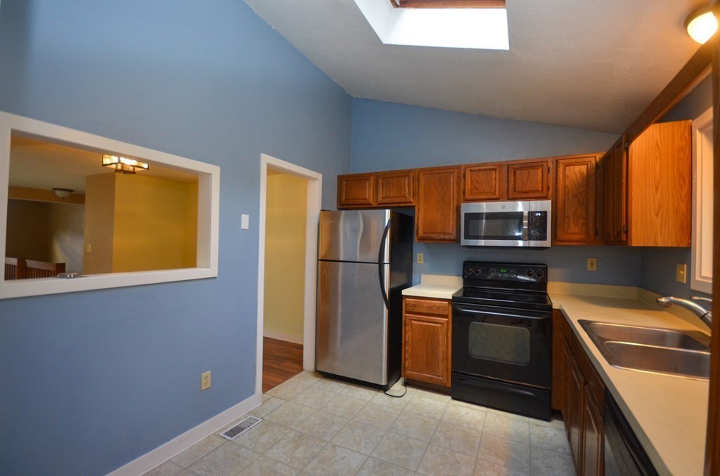 19 Millers Way, Unit C Sutton, MA 01590 - Photo 10 of 37 a kitchen with stainless steel appliances a stove top oven a sink and a refrigerator