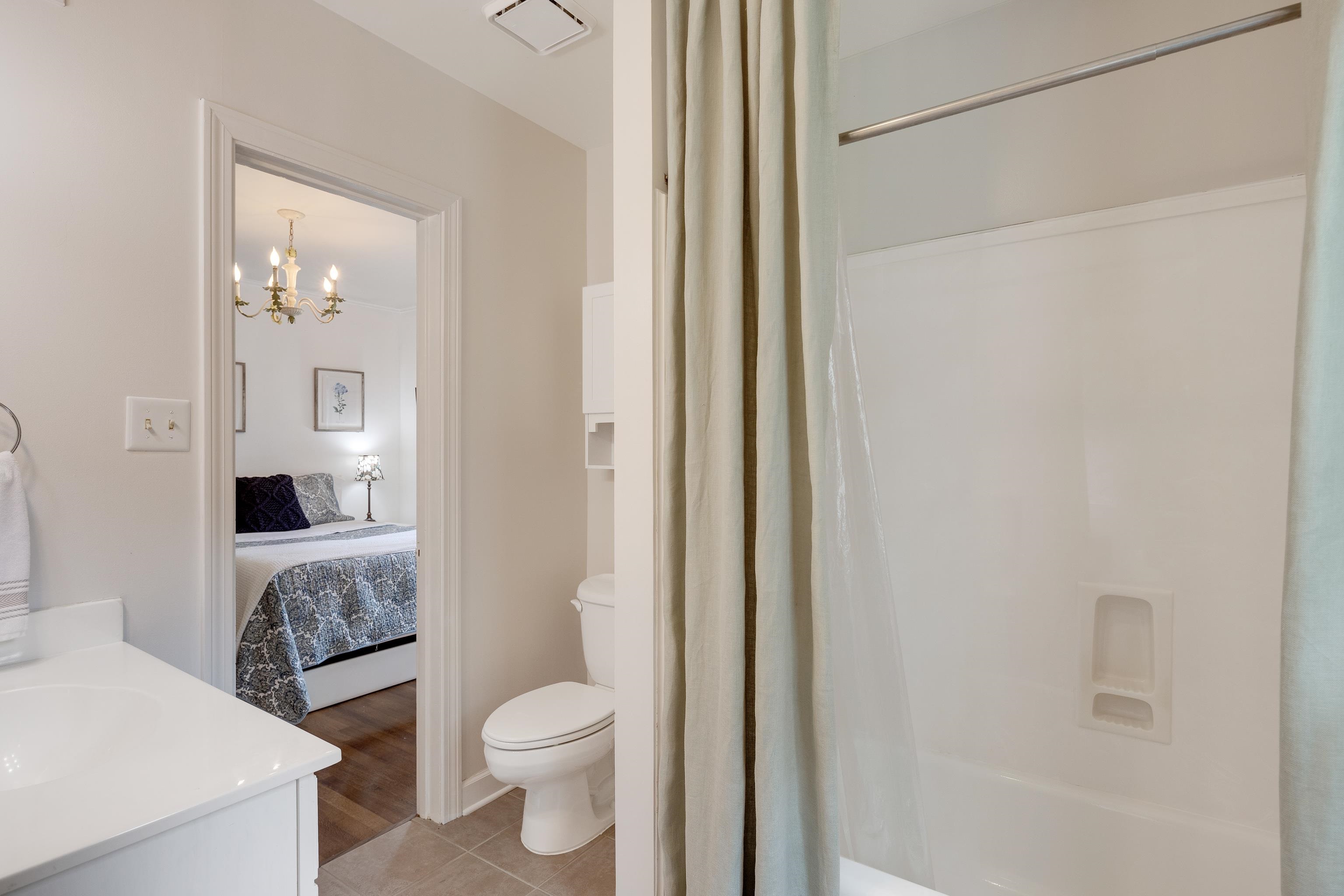 5371 South Angela Road Memphis, TN 38120 - Photo 17 of 25 a bathroom with a granite countertop toilet a sink and a mirror