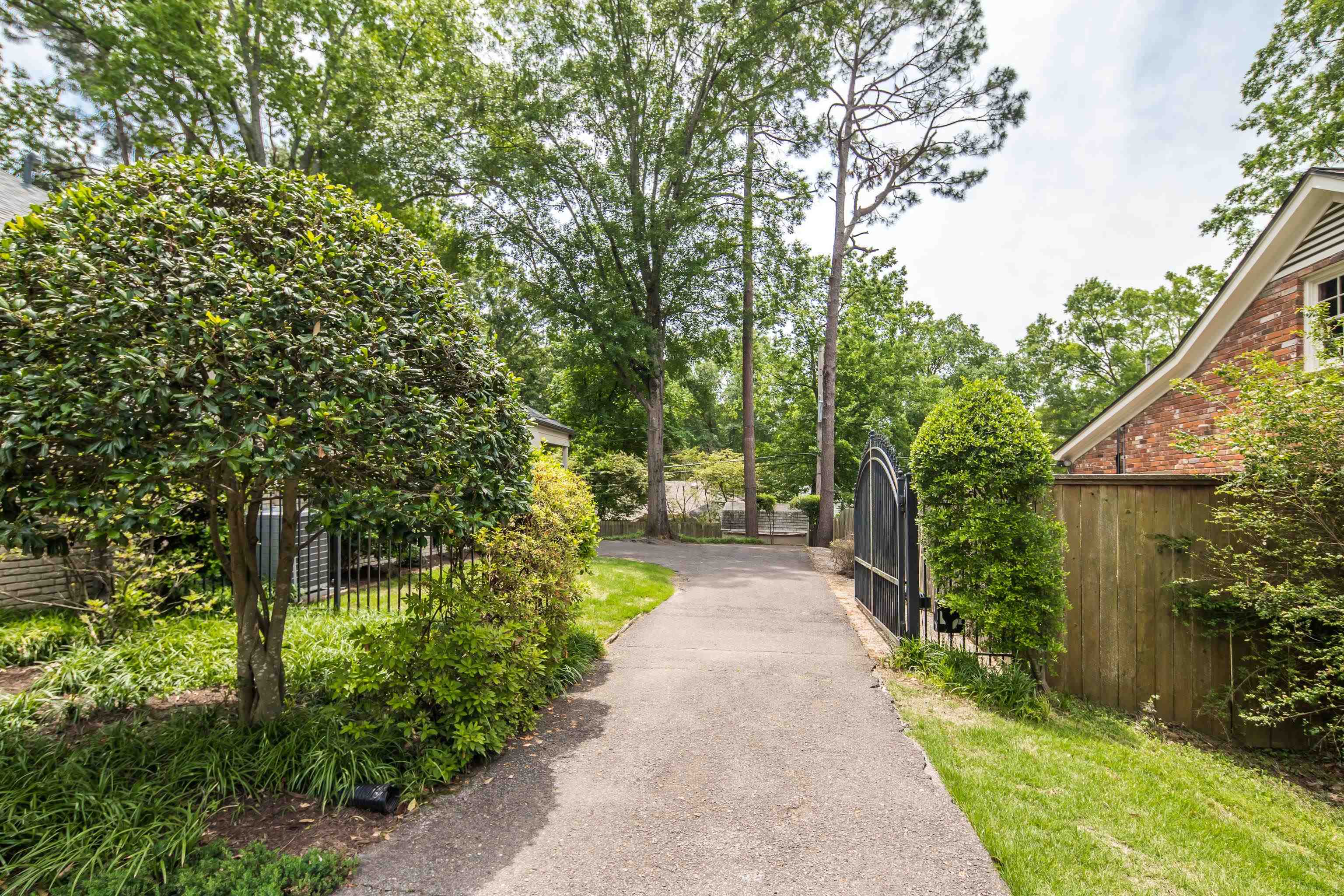 5371 South Angela Road Memphis, TN 38120 - Photo 2 of 25 a view of a pathway of a house with a tree