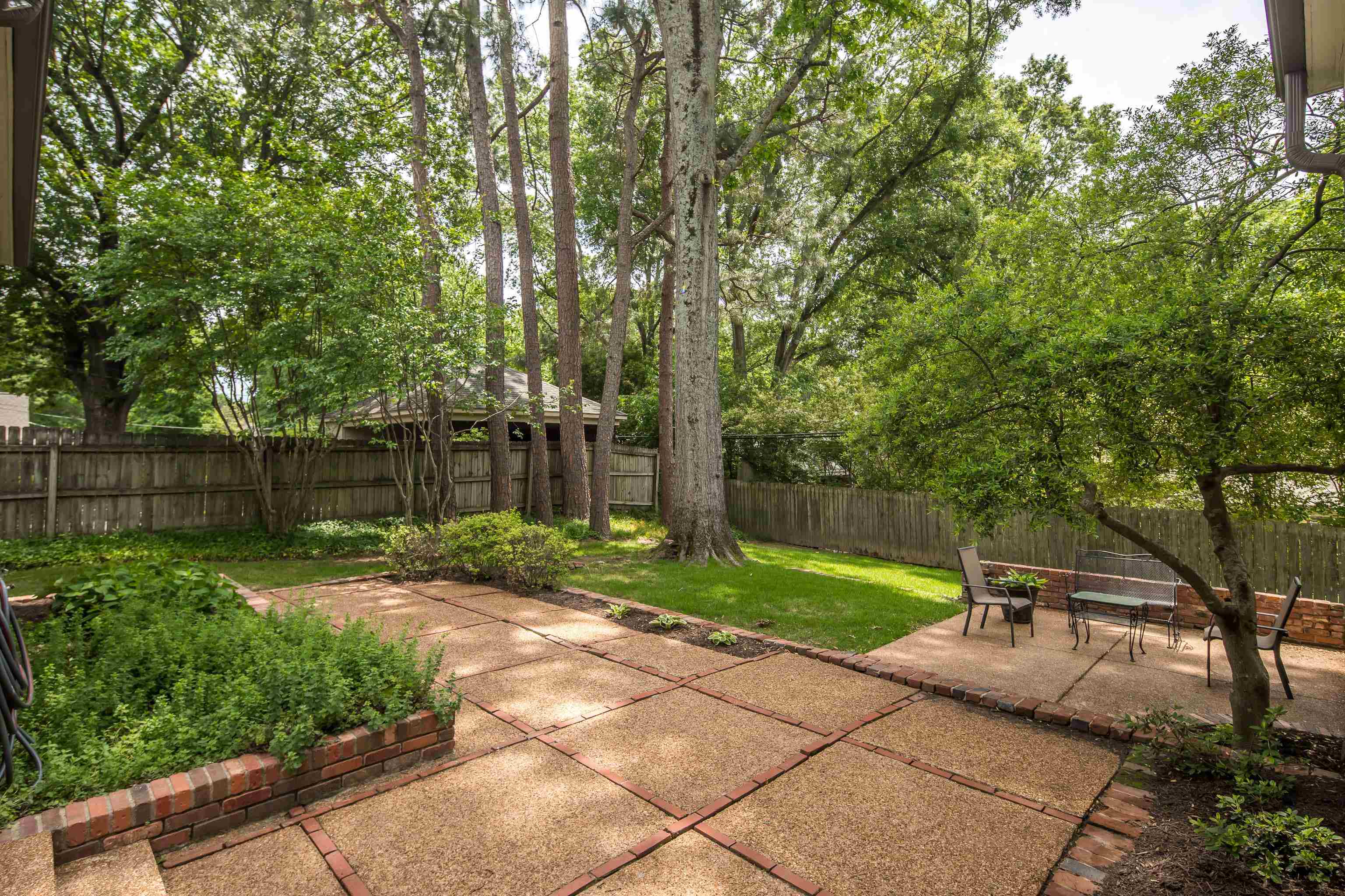 5371 South Angela Road Memphis, TN 38120 - Photo 23 of 25 a garden with trees in the background
