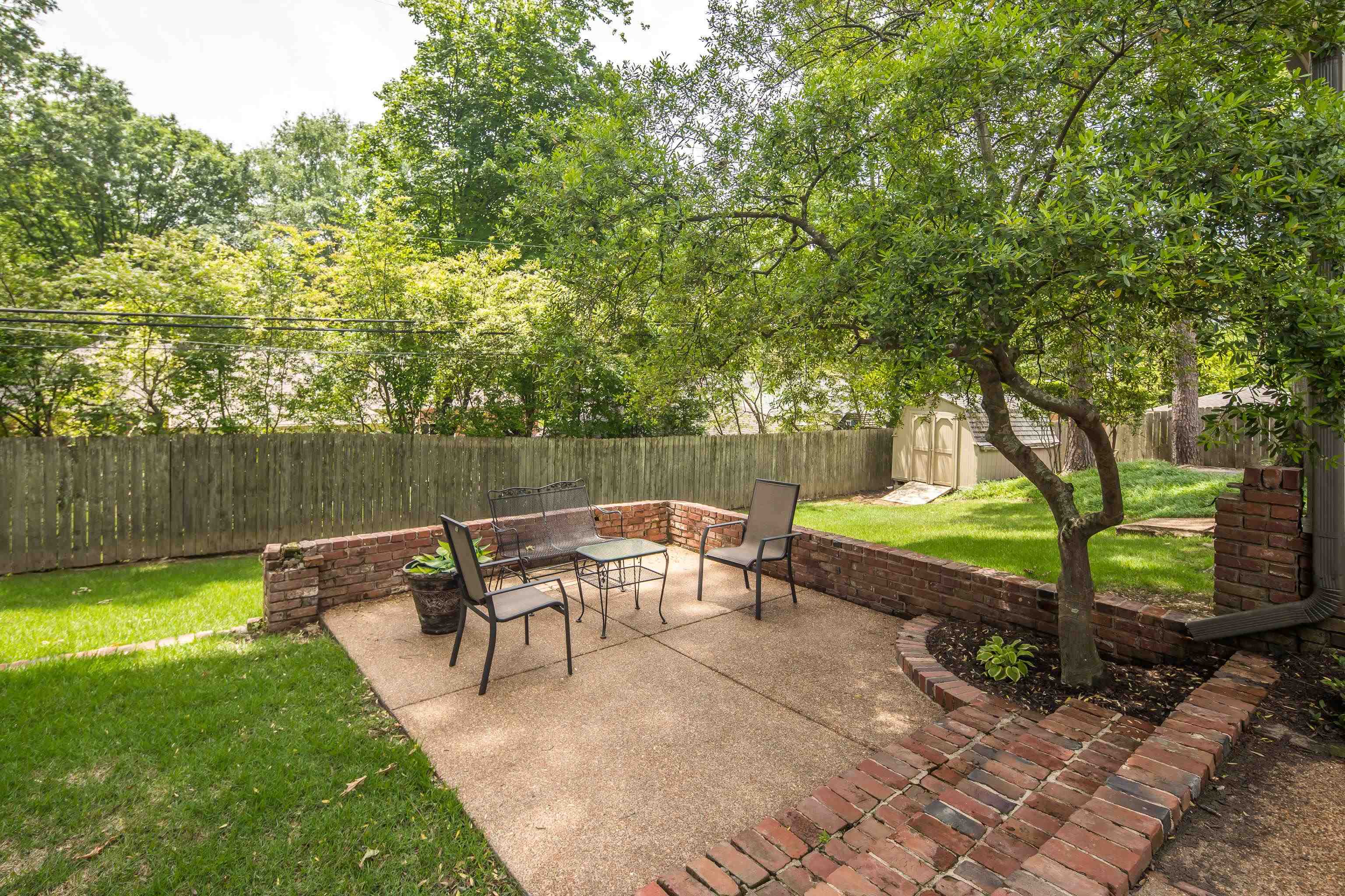 5371 South Angela Road Memphis, TN 38120 - Photo 24 of 25 an outdoor sitting area with couch and trees