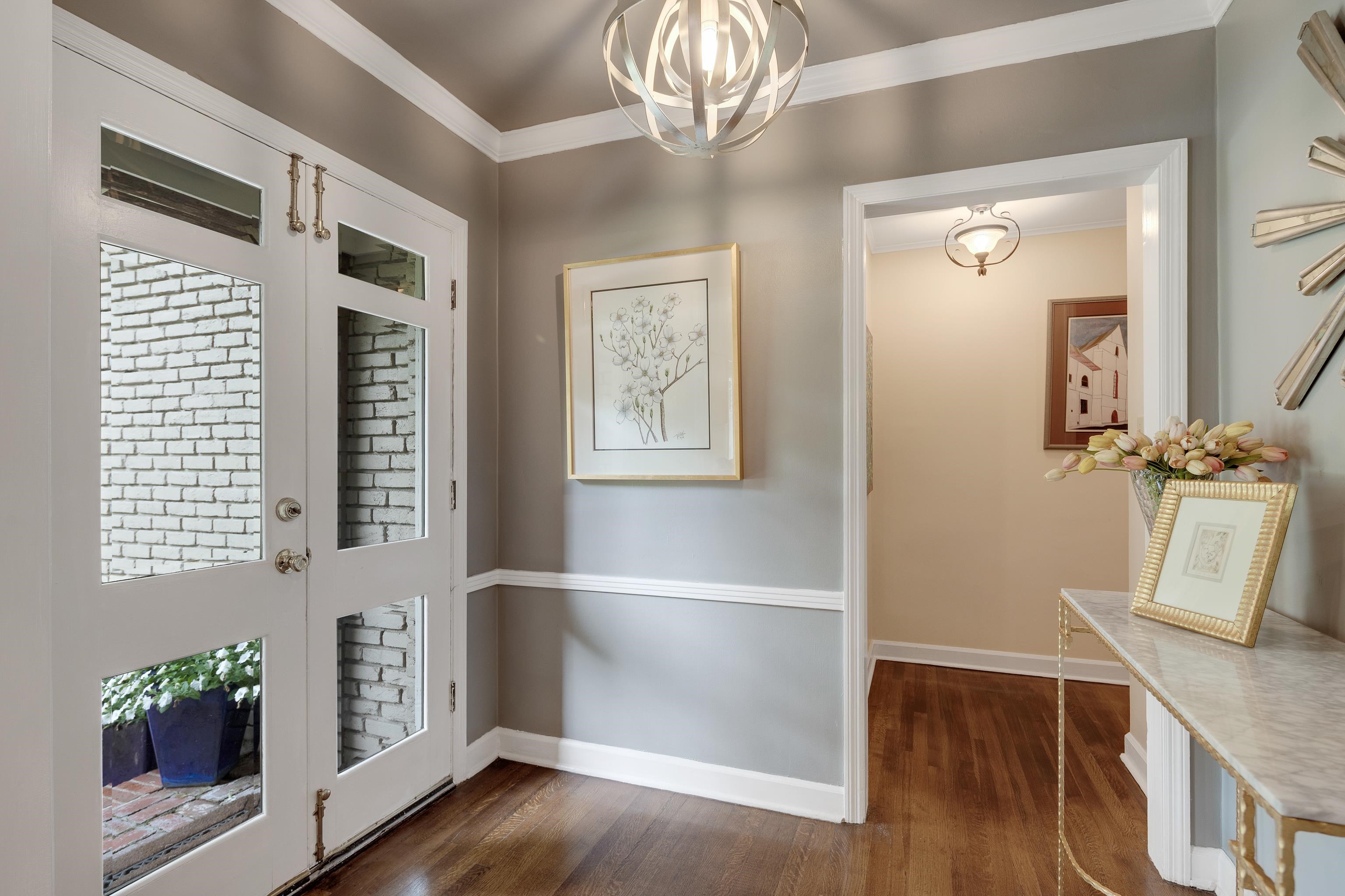 5371 South Angela Road Memphis, TN 38120 - Photo 4 of 25 a view of a hallway with wooden floor and a chandelier