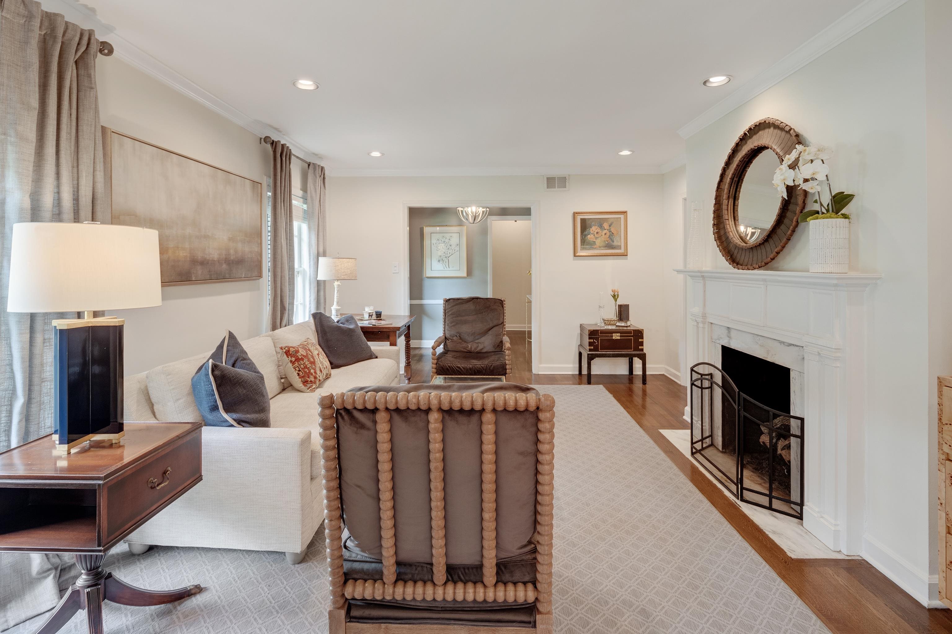 5371 South Angela Road Memphis, TN 38120 - Photo 7 of 25 a living room with furniture a fireplace and a large mirror