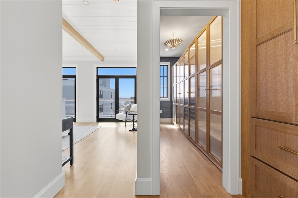 847 East 5th Street, Unit 2 Boston, MA 02127 - Photo 18 of 24 a view of a hallway with wooden floor and windows