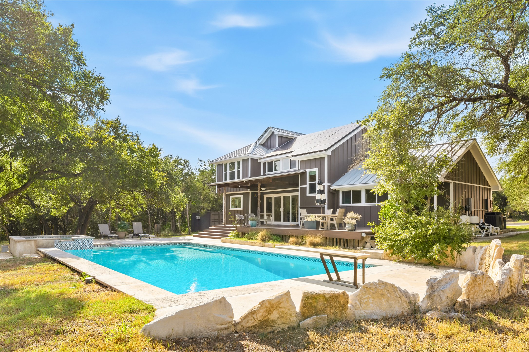 12901 Wire Road Leander, TX 78641 - Photo 27 of 40 Mature trees frame a sparkling backyard swimming pool and spacious elevated deck.