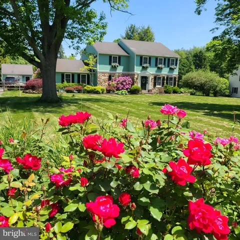 a view of a house with yard and sitting area