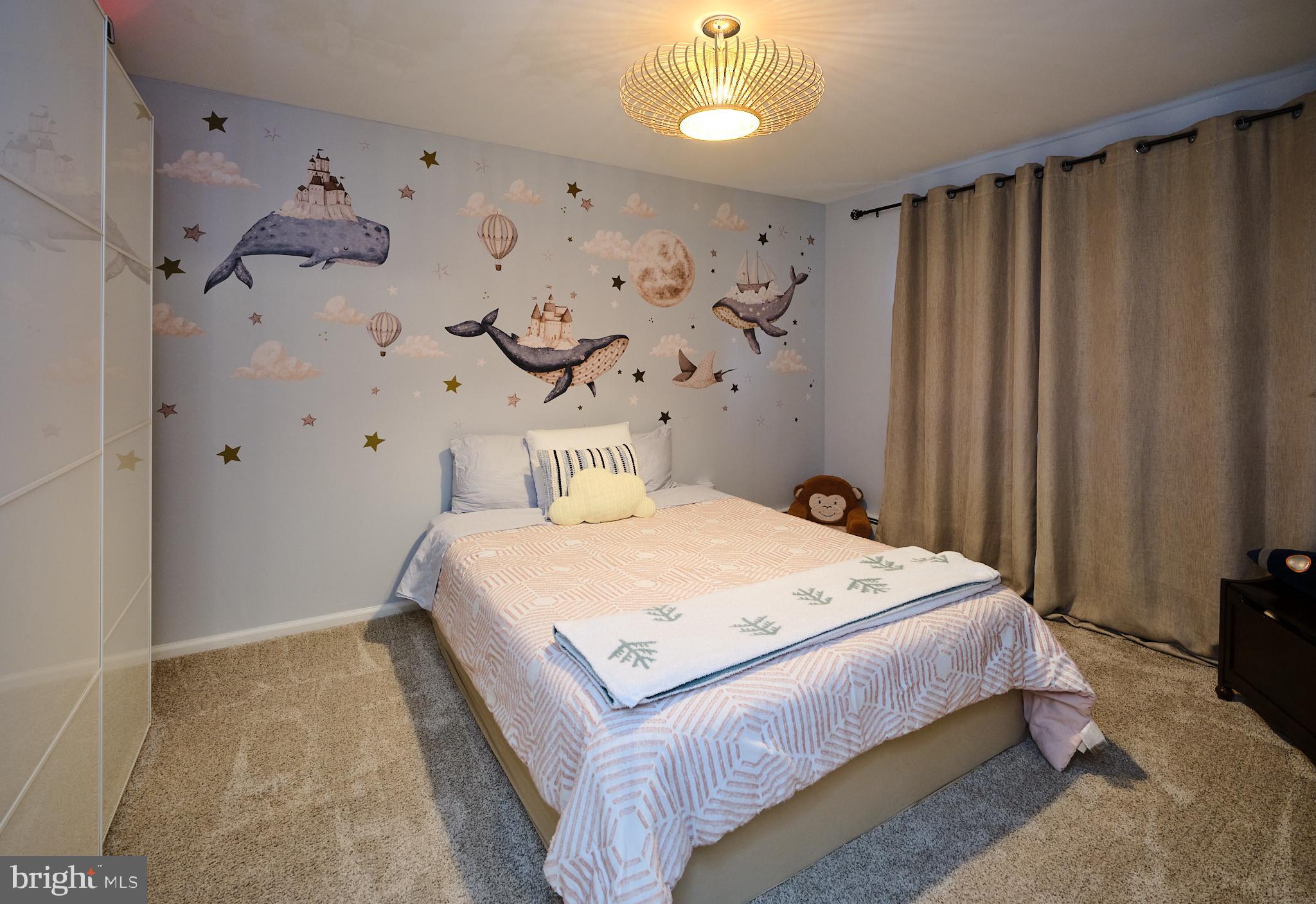 3889 Robin Road Furlong, PA 18925 - Photo 30 of 48 a bedroom with a bed and a chandelier