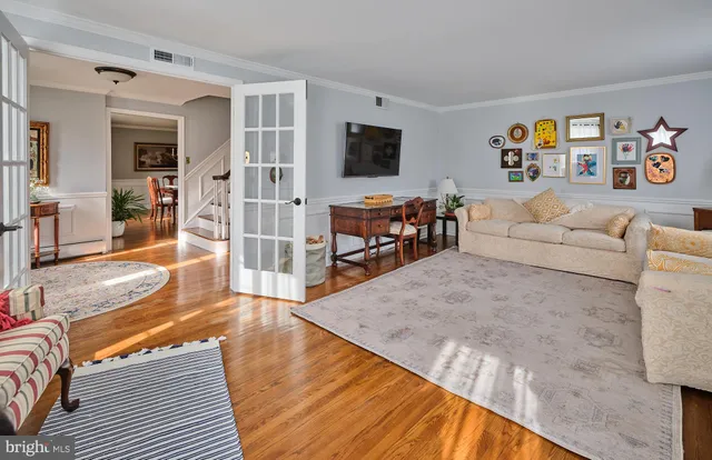 a view of a hallway with wooden floor and staircase