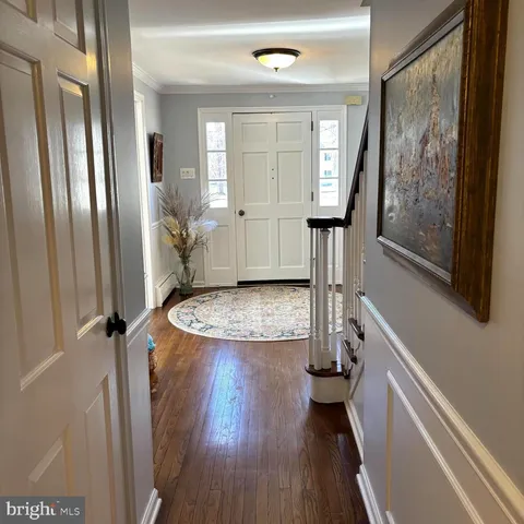 a view of a dining room with furniture wooden floor and chandelier