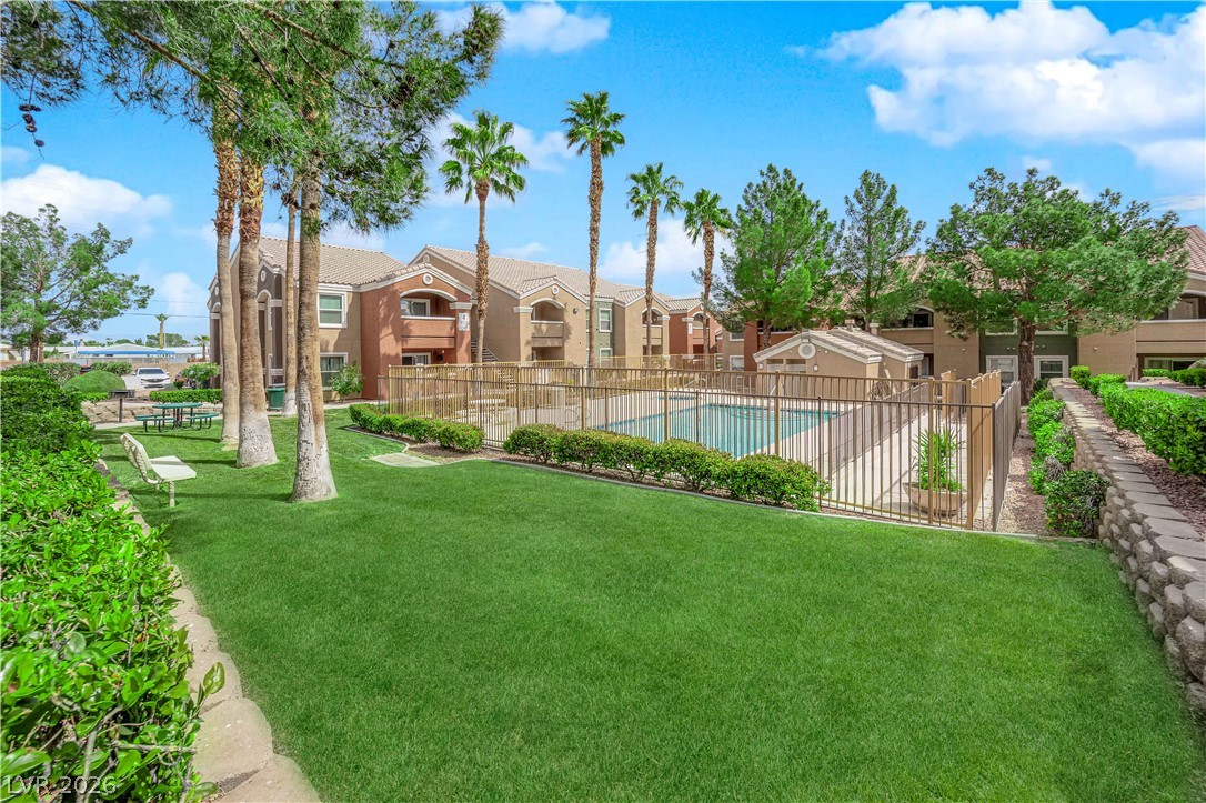 8101 West Flamingo Road, Unit 2030 Las Vegas, NV 89147 - Photo 5 of 27 Lush landscaping and a shimmering pool beckon, creating an idyllic community setting.