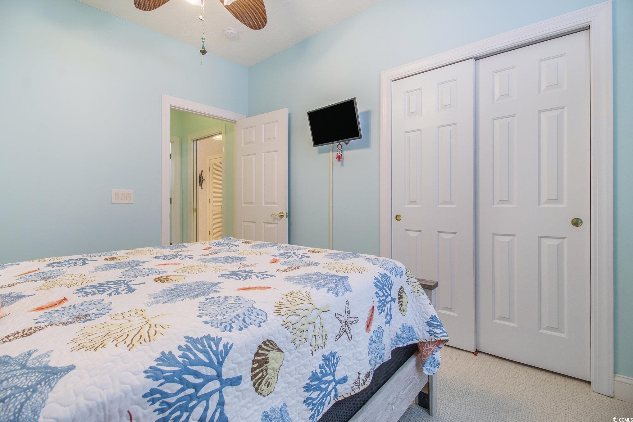 1141 Peace Pipe Place, Unit 101 Myrtle Beach, SC 29579 - Photo 15 of 28 Bedroom featuring a closet, light colored carpet, and ceiling fan