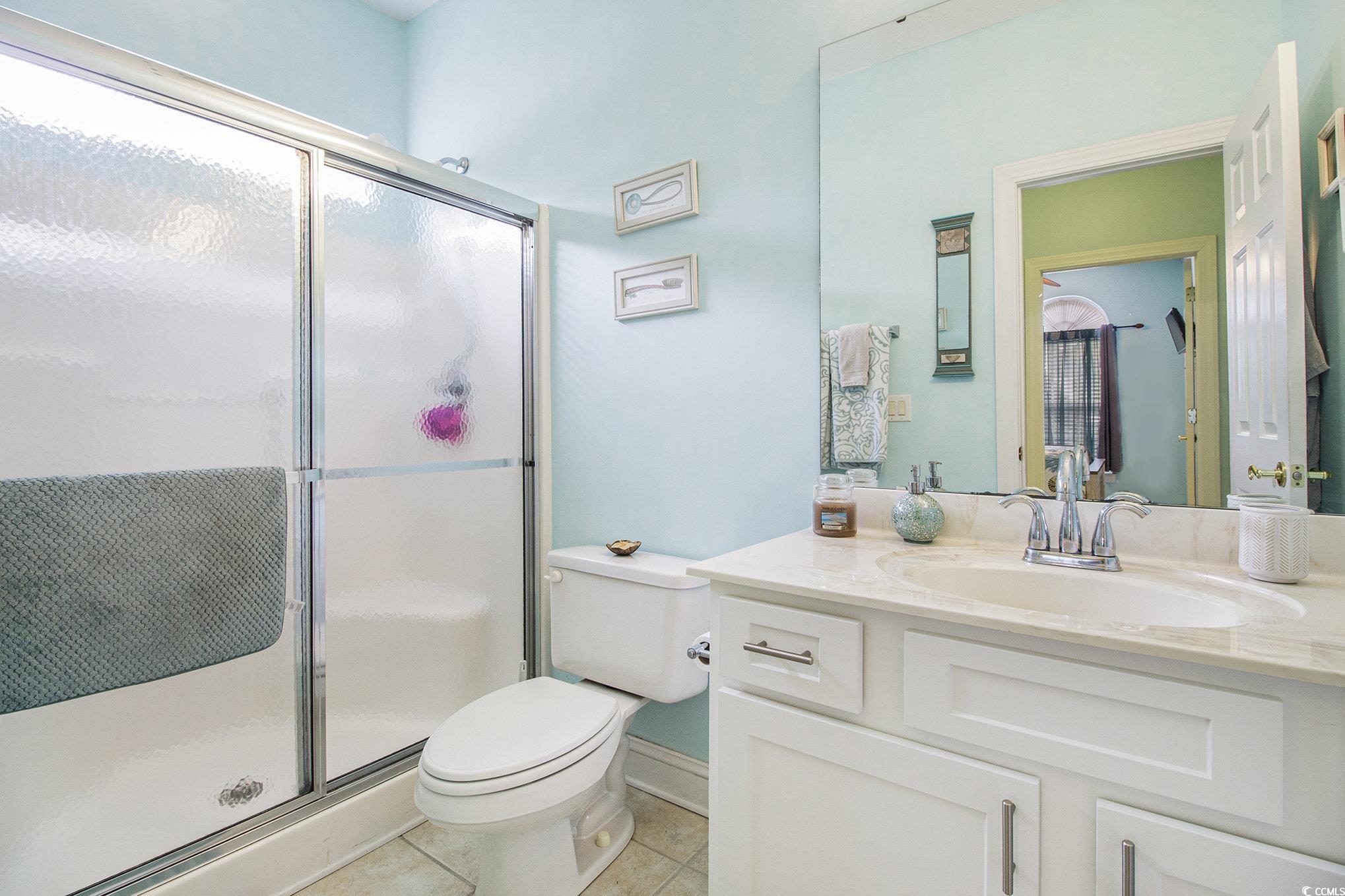 1141 Peace Pipe Place, Unit 101 Myrtle Beach, SC 29579 - Photo 16 of 28 Full bathroom featuring vanity, a stall shower, and tile patterned floors
