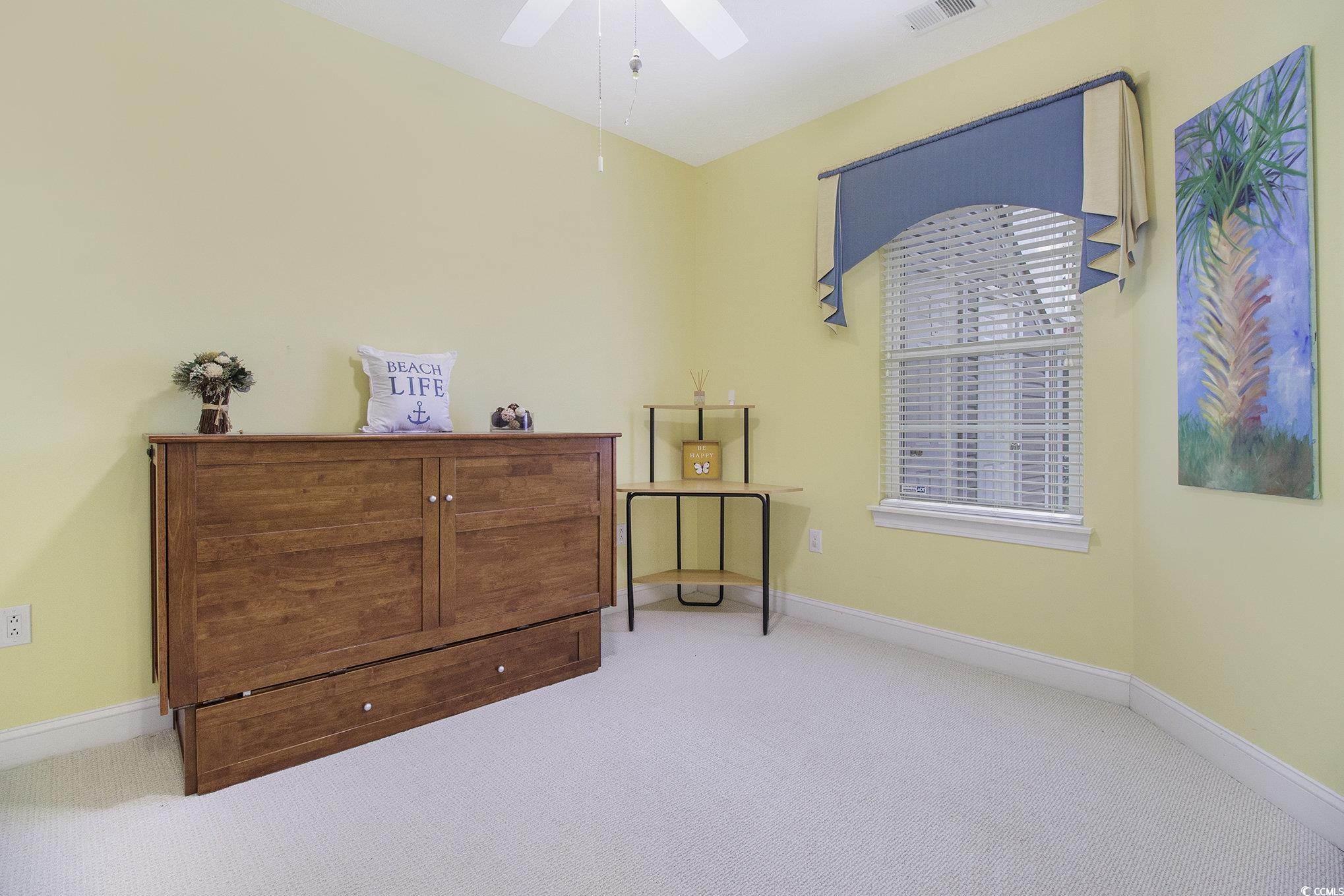 1141 Peace Pipe Place, Unit 101 Myrtle Beach, SC 29579 - Photo 17 of 28 Bedroom with carpet floors and a ceiling fan