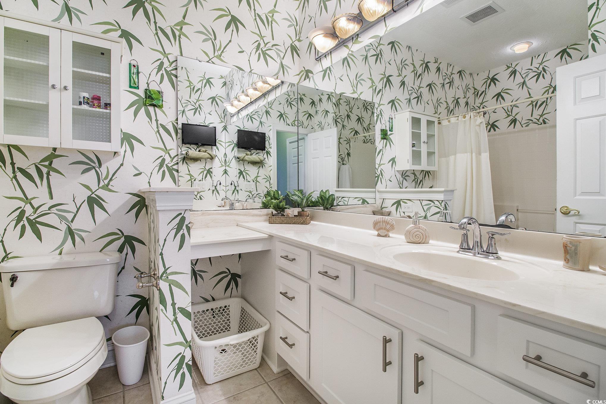 1141 Peace Pipe Place, Unit 101 Myrtle Beach, SC 29579 - Photo 21 of 28 Full bathroom with wallpapered walls, tile patterned floors, vanity, and curtained shower