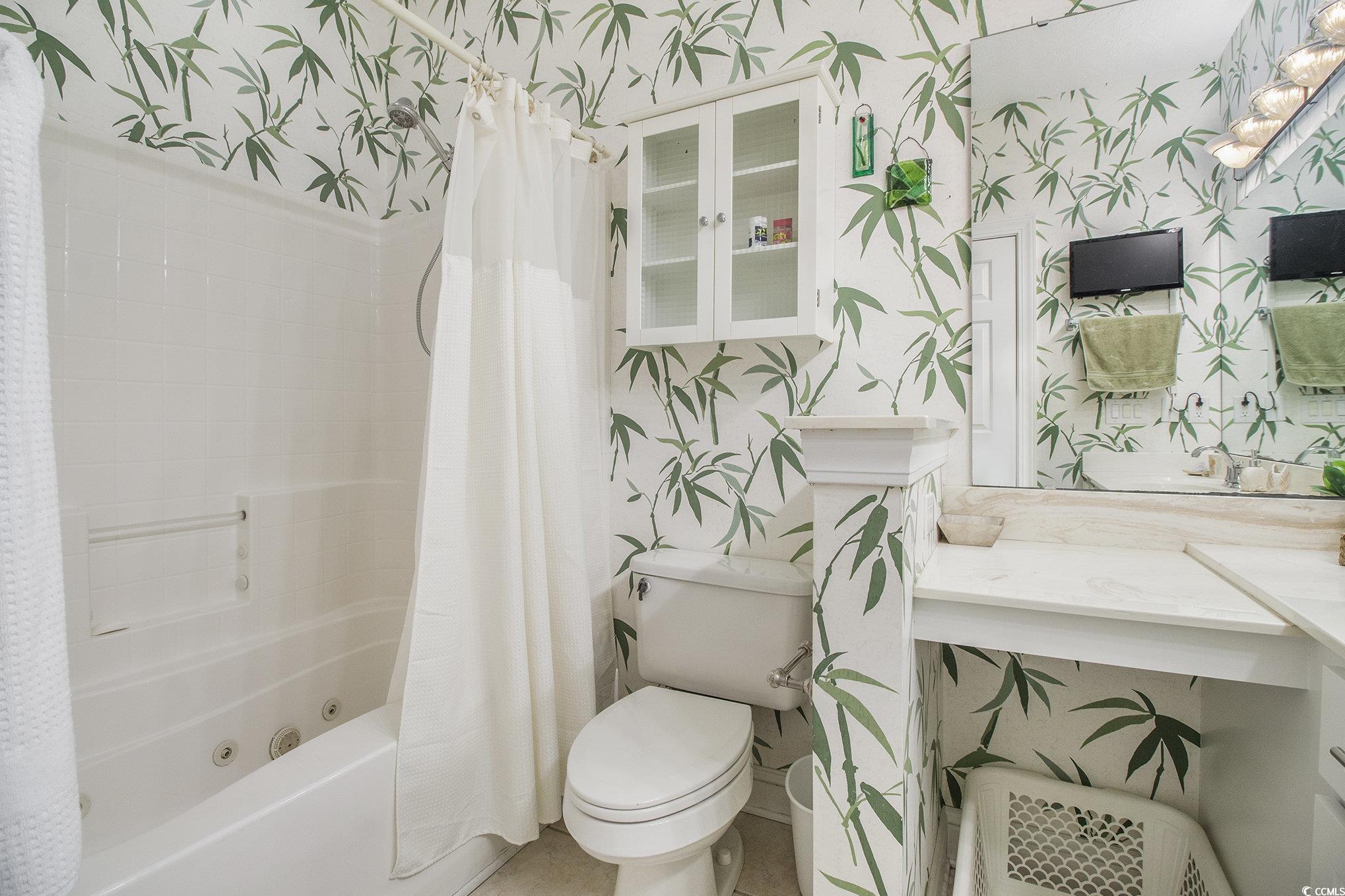 1141 Peace Pipe Place, Unit 101 Myrtle Beach, SC 29579 - Photo 22 of 28 Bathroom featuring wallpapered walls, a combined bath / shower with jetted tub, and vanity