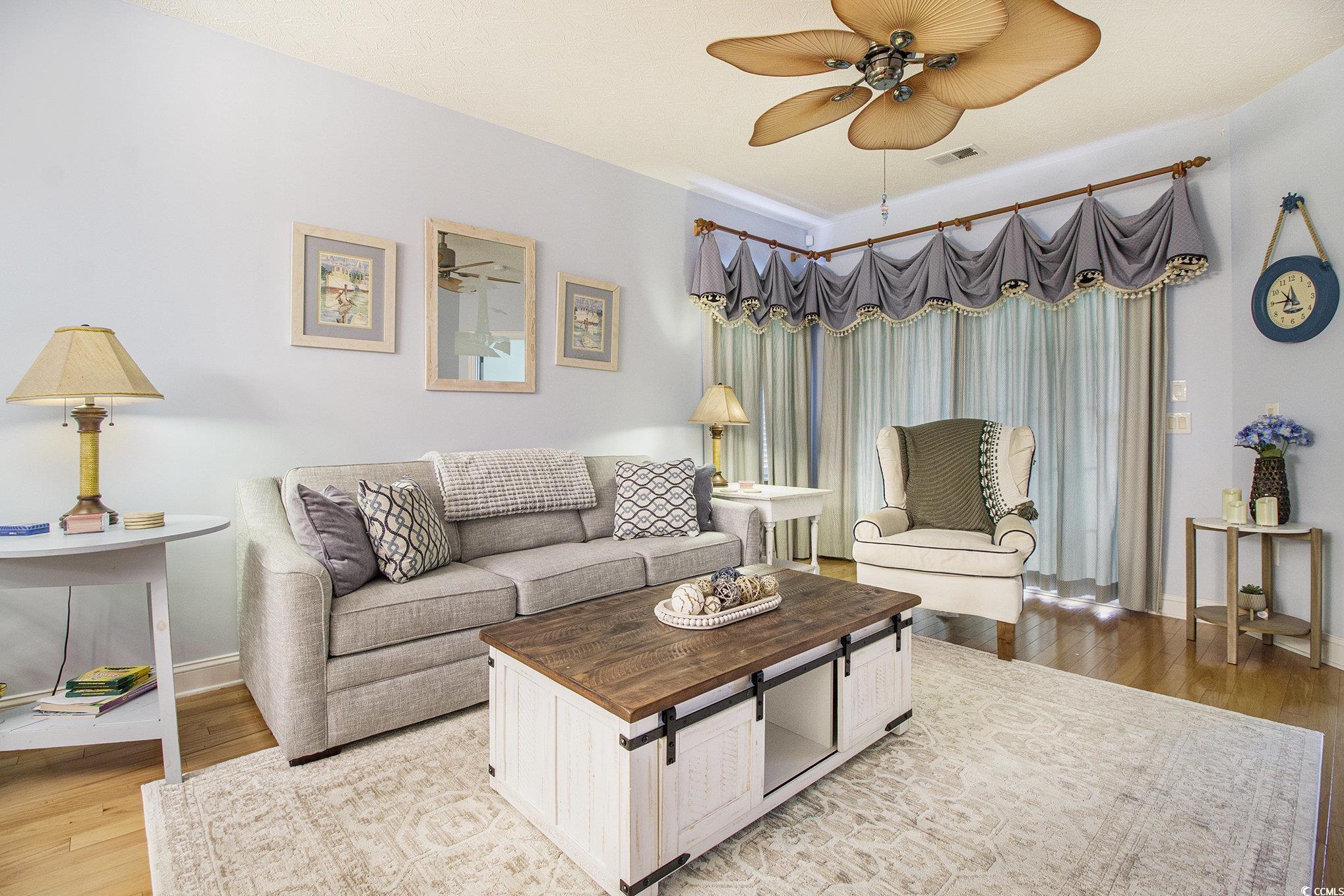 1141 Peace Pipe Place, Unit 101 Myrtle Beach, SC 29579 - Photo 6 of 28 Living room with ceiling fan and light wood-type flooring