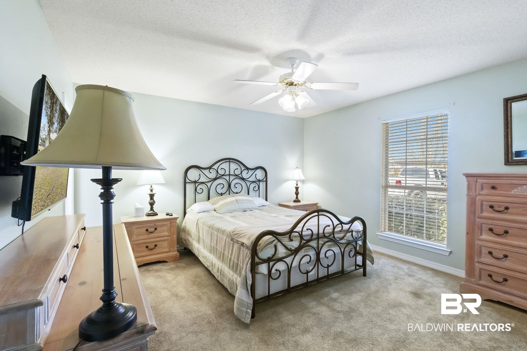 14031 Brook Hollow Road Summerdale, AL 36580 - Photo 26 of 56 Carpeted bedroom with ceiling fan and a textured ceiling
