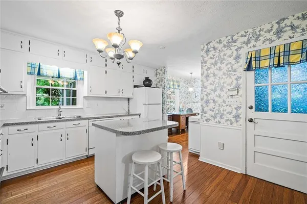 a kitchen with stainless steel appliances granite countertop a sink stove and wooden floor