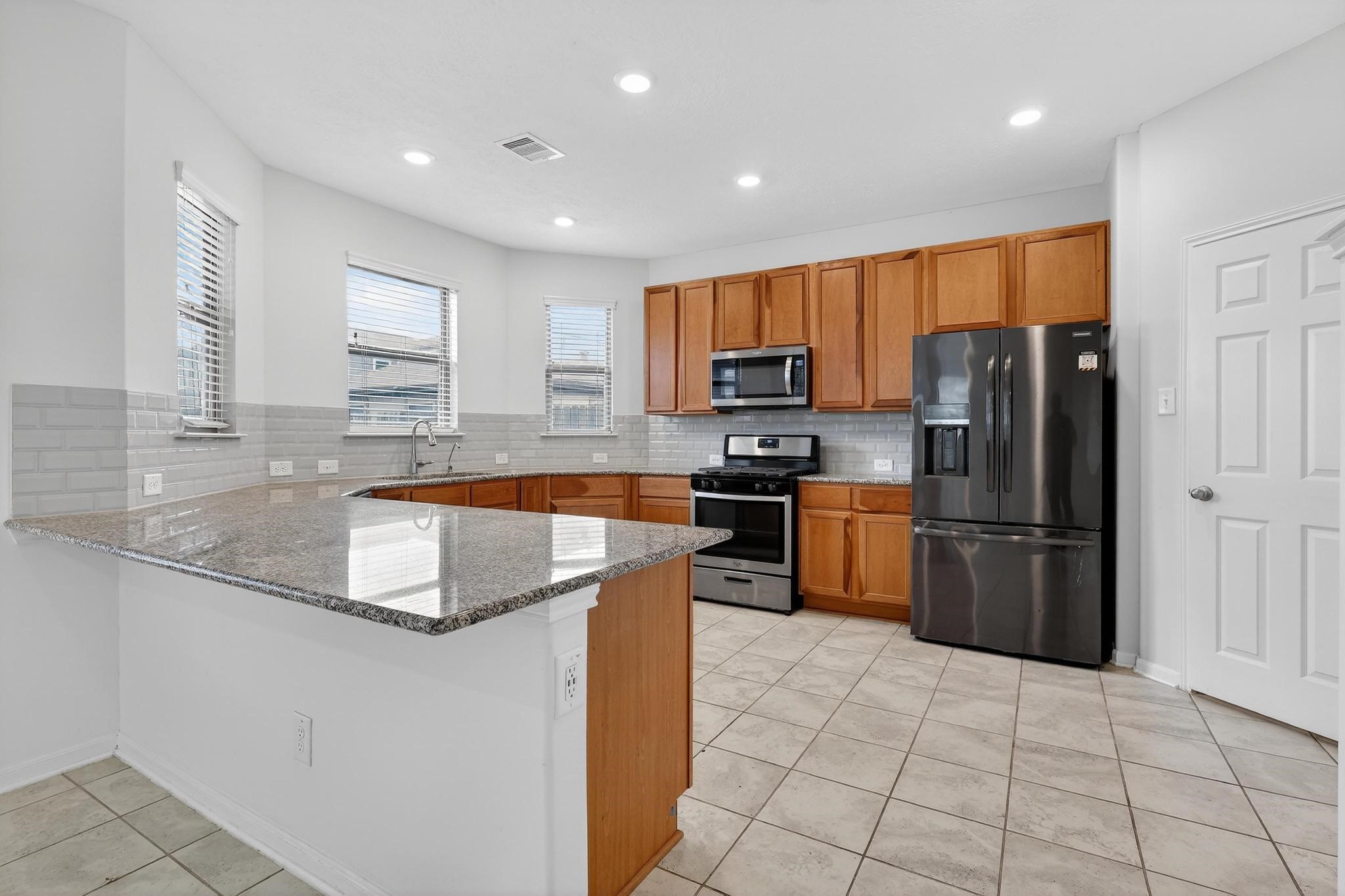 3322 Nila Creek Dr Spring Spring, TX 77373 - Photo 7 of 36 Spacious kitchen featuring a large center island, abundant cabinetry, and plenty of counter space for cooking and entertaining.