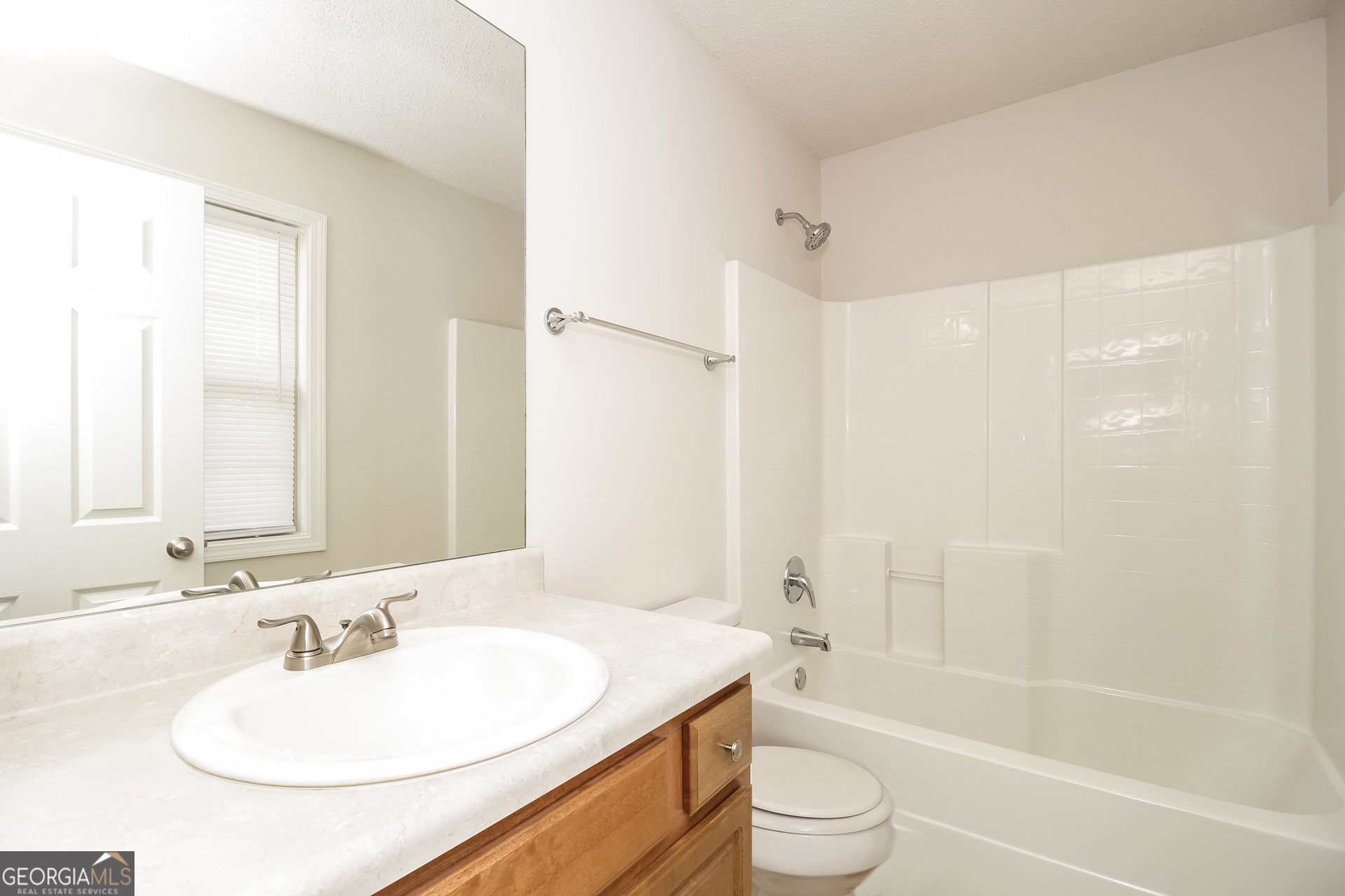 82 Gilliam Crossing Cartersville, GA 30120 - Photo 16 of 17 a bathroom with a bathtub shower sink vanity mirror and toilet