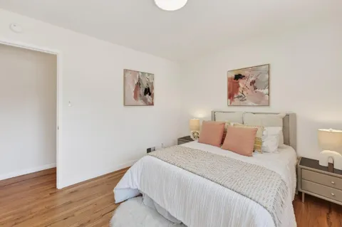 a bedroom with bed and cupboard