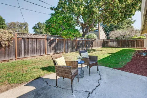 a view of backyard with seating and green space