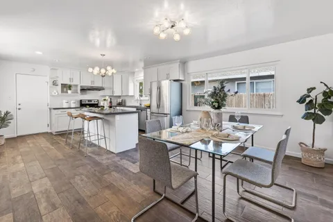 a kitchen with a table and chairs in it