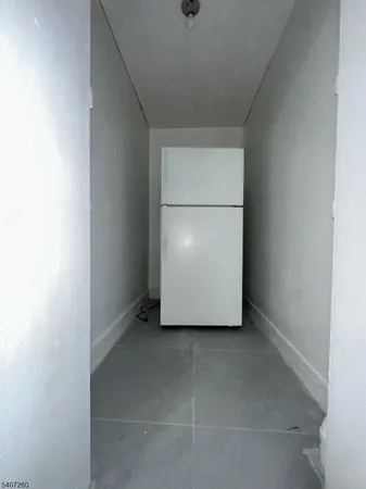 an empty room with wooden floor and a window